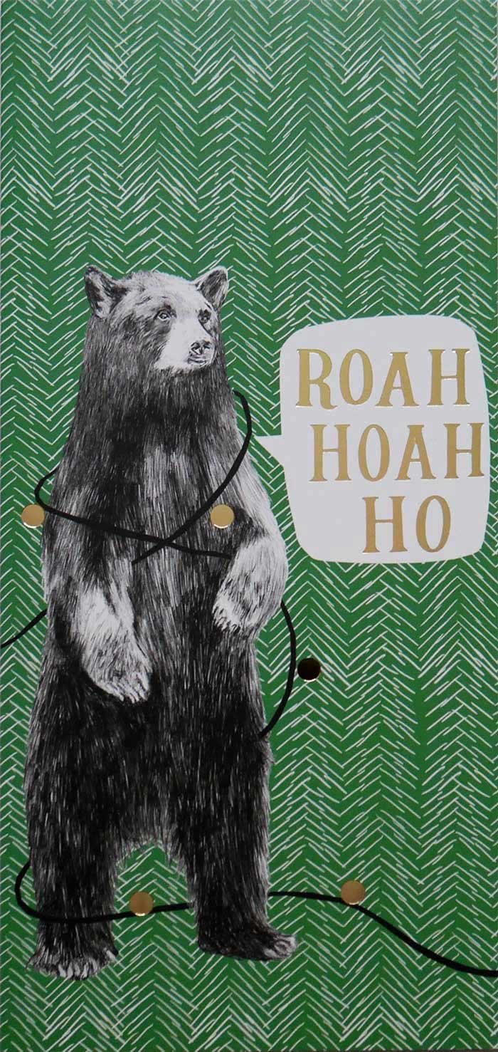 Photo of a Christmas card which has a green background with a white hand-drawn herringbone pattern. A bear tangled in Christmas baubles says 'Roah Hoah Ho'. The text and baubles are highlighted with gold foil.